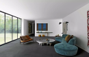 Salon z dużymi oknami, turkusową kanapą, fotelem, stolikiem kawowym i podłogą imitującą beton Florim Creative Design Studios Rubber