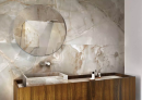 Łazienka w stylu glamour z drewnianą szafką, marmurową umywalką nablatową, srebrną baterią, lustrem i płytkami na ścianie imitującymi marmur Florim Luxury Design Reves Reve Noisette
