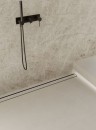 Ściana wyłożona połyskującymi szarymi płytkami imitującymi marmur, Marazzi Grande Marble Look Taj Mahal Lux