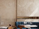 Restauracja z beżowymi, dekoracyjnymi płytkami na ścianie, imitującymi marmur Porcelanosia Line Beige Velluto