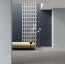 Wnętrze z szarymi płytkami podłogowymi imitującymi beton Caesar Join Levity oraz błękitnymi ściennymi Caesar Join Sky i ciemnoniebieskimi Join Ink