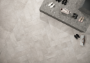 Butik z szarą płytką podłogową imitującą beton Caesar I.MAT Rule