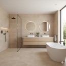 Łazienka wyłożona beżowymi płytkami gresowymi 60x60 cm z kolekcji Marazzi Mystone Tivoli Beige MQC4, w rogu stoi owalna biała wanna, łazienka ustrojona czarną armaturą