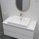Oltens Gota bateria umywalkowa stojąca złoty połysk 32201800 - bateria zamontowana na białej umywalce w towarzystwie białych płytek oraz lustra ze złotą ramką