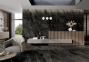 Gres Graniti Dark Paradise 60x120 w prestiżowym lobby. Ciemne, użylone płyty pokrywają podłogę i ścianę za recepcją z drewnianymi lamelami. Nowoczesny fotel, minimalistyczne oświetlenie i duże przeszklenia podkreślają luksusowy, monumentalny charakter.