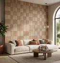Salon z płytkami Marazzi ArtCraft Coccio Struttura 3D Bande 20x20 cm MGUJ. Ściana dekoracyjna w ciepłych odcieniach terakoty z trójwymiarową strukturą pasów za jasną sofą. Naturalne światło podkreśla efekt 3D i rzemieślniczy charakter ceramiki.