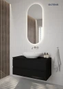 Oltens Nordlis lustro 50x120 cm owalne z oświetleniem od tyłu z matą grzewczą 64114000 - lustro powieszone w łazience na jasnej ścianie razem z czarną szafką oraz białą umywalką