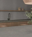 Ecoceramic Kora Coffee Matt 60x120- gresowa płytka imitująca grafitowy beton z brązowymi przebarwieniami na blacie wyspy kuchennej. Ciemno drewniana zabudowa kuchenna. Grafitowy kamienny blat i czarna armatura kuchenna.