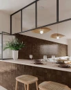 Gayafores Deco Amaris Plus Cacao 32x62,5-  ścienna dekoracyjna płytka, brązowy kwadrat w postacie prostokątnej płytki na ścianach restauracji. Biały kamienny blat na wyspie, czarne metalowe elementy dekoracyjne.