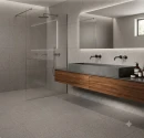 Nowoczesna łazienka w płytkach Marazzi SistemT - Graniti Medio Diamond 20x20 cm M7K5 na ścianach i podłodze. Widoczna drewniana szafka z betonową umywalką, czarne baterie, podświetlane lustro oraz minimalistyczny prysznic walk-in.