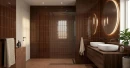 Aranżacja łazienki z płytkami ściennymi WOW Bits Chestnut Gloss 3,7x11,6 cm (132997), ułożonymi pionowo. W pomieszczeniu znajduje się prysznic walk-in z ciemnym profilem, podwójna umywalka nablatowa na drewnianej szafce i okrągłe lustro.