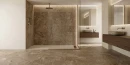 Łazienka z płytkami imitującymi kamień, antypoślizgowymi, podłogowymi, matowymi Cifre Arcata Stone Terra Sl Antislip 30x60 SL, z kabiną otwartą typu walk-in, złotą szczotkowaną armaturą, drewnianymi podwieszanymi szafkami w kolorze orzechowym, lustrami.
