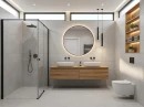 Szara łazienka z płytkami ściennymi, imitującymi beton Cifre Acron Pearl Mate Xs Rect. 40x120, z czarną armaturą, drewnianą podwieszaną szafką umywalkową, drewniana półką, szklanym prysznicem walk-in, minimalistycznymi dodatkami.